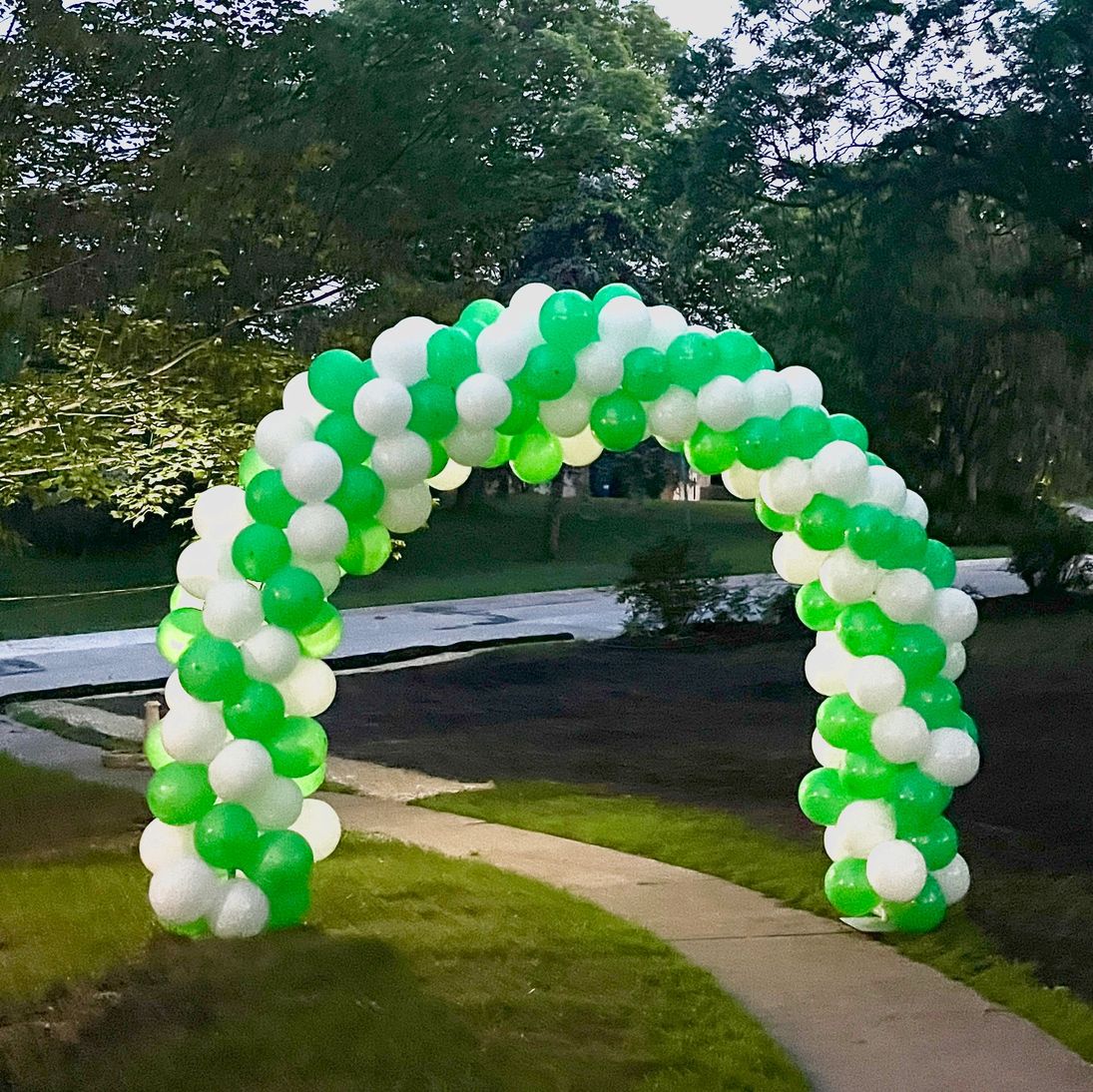 Green and white balloon arch